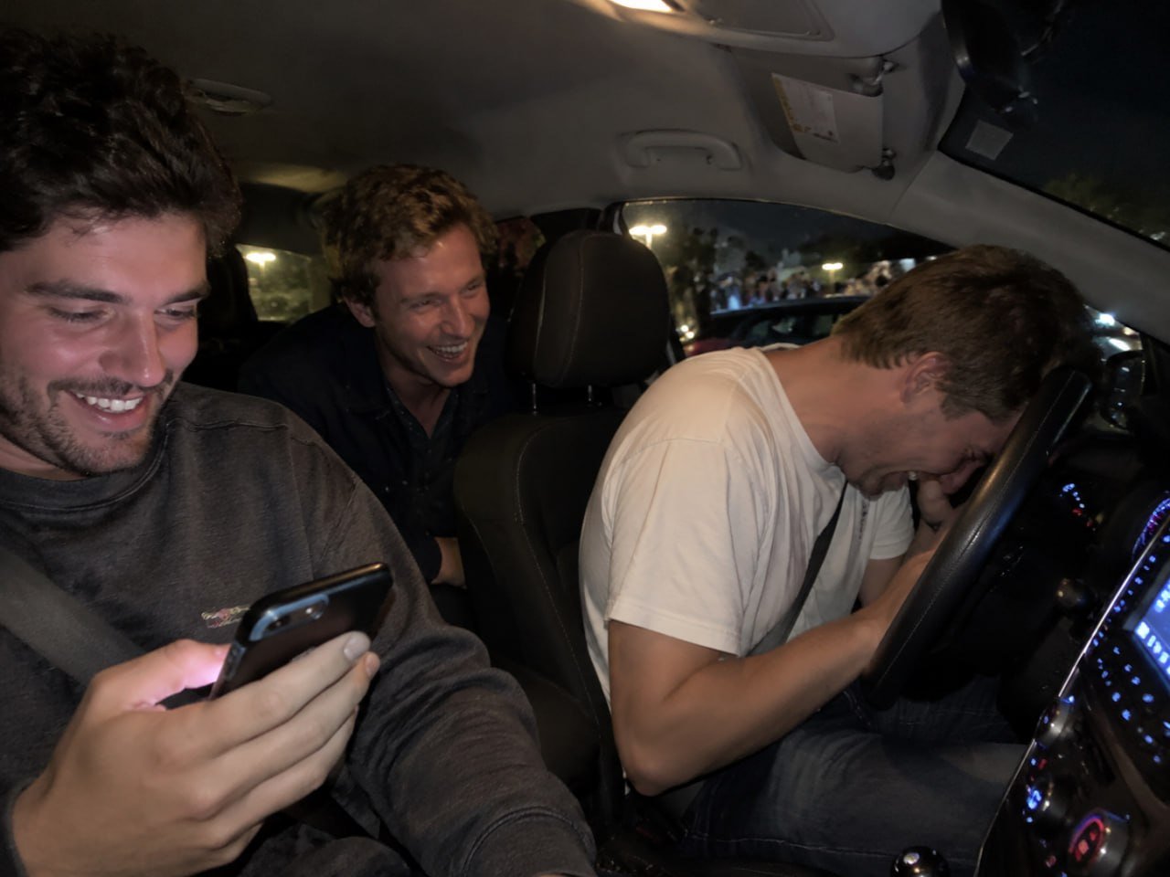 Friends cracking up at a house party